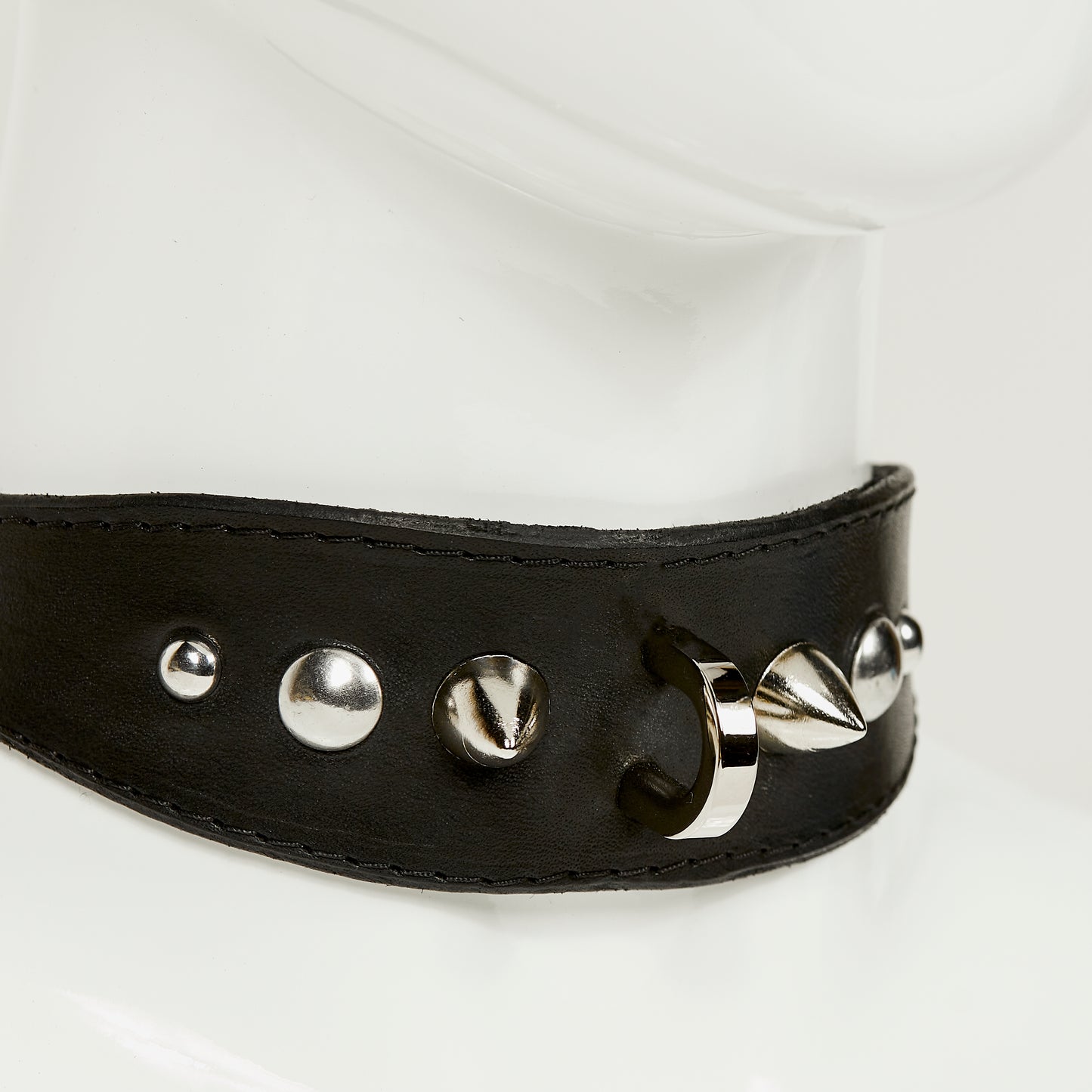NIKKI COLLAR 3/4 close front view of medium width collar necklace in black leather with black stitched edges, accented with a gradation of silver rivets, spikes, and d-ring hardware