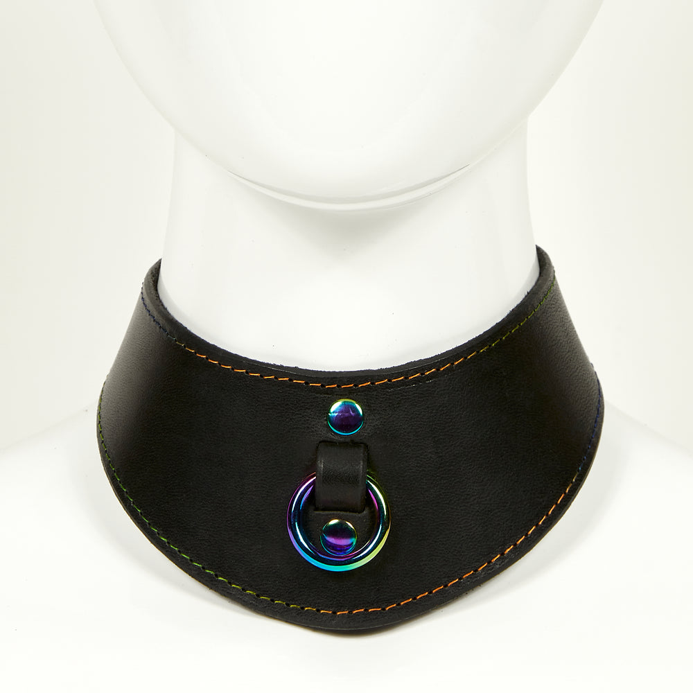 NAOMI COLLAR front view of wide, curved style collar in black leather with rainbow stitched edges, rainbow o-ring suspended from a strap tucked into collar, riveted with rainbow hardware