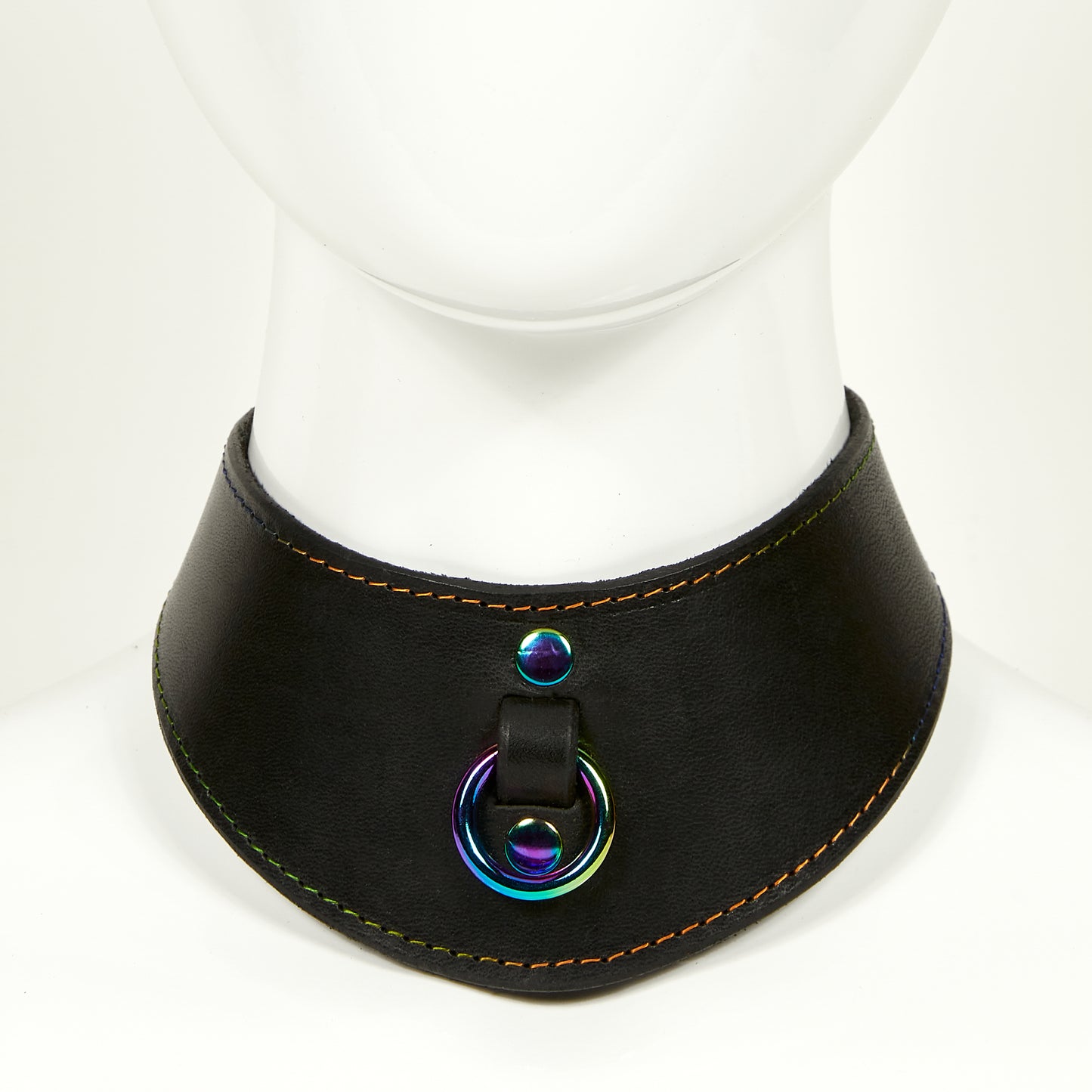 NAOMI COLLAR front view of wide, curved style collar in black leather with rainbow stitched edges, rainbow o-ring suspended from a strap tucked into collar, riveted with rainbow hardware