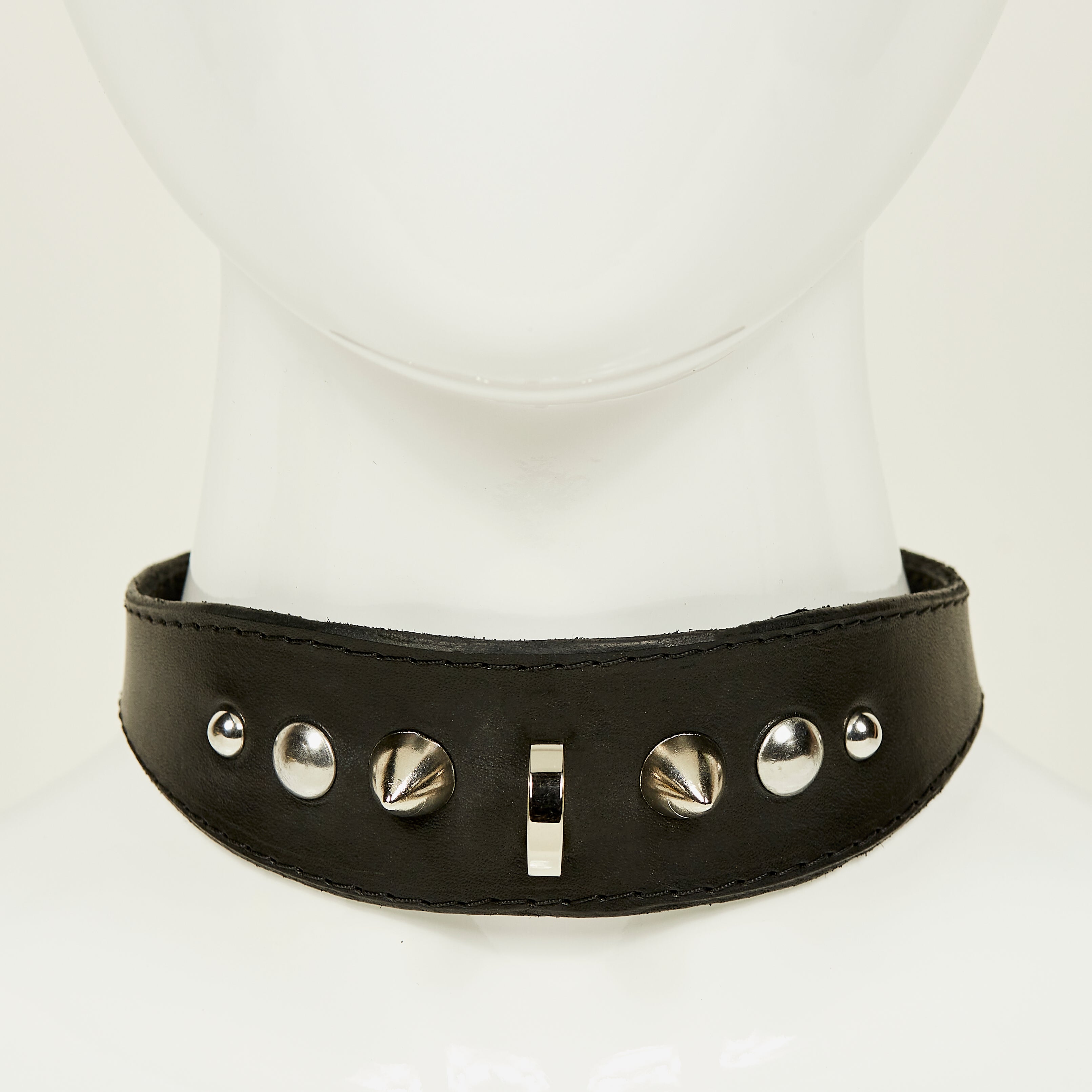 NIKKI COLLAR front view of medium width collar necklace in black leather with black stitched edges, accented with a gradation of silver rivets, spikes, and d-ring hardware