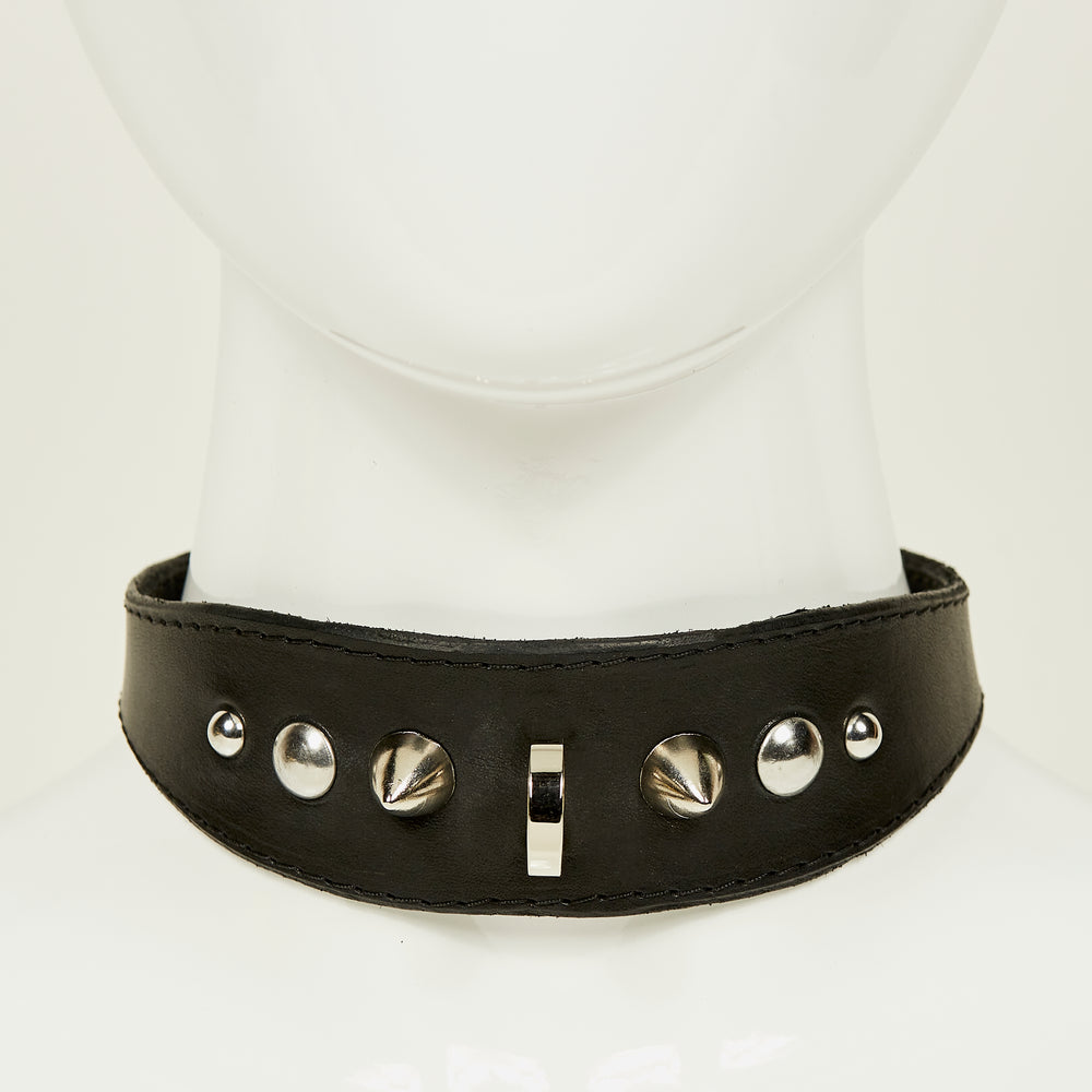 NIKKI COLLAR front view of medium width collar necklace in black leather with black stitched edges, accented with a gradation of silver rivets, spikes, and d-ring hardware
