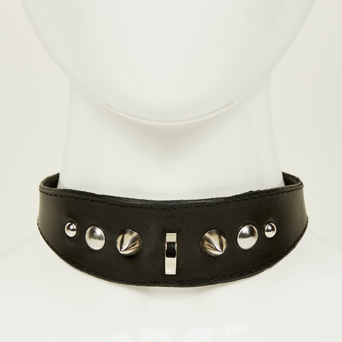 NIKKI COLLAR front view of medium width collar necklace in black leather with black stitched edges, accented with a gradation of silver rivets, spikes, and d-ring hardware