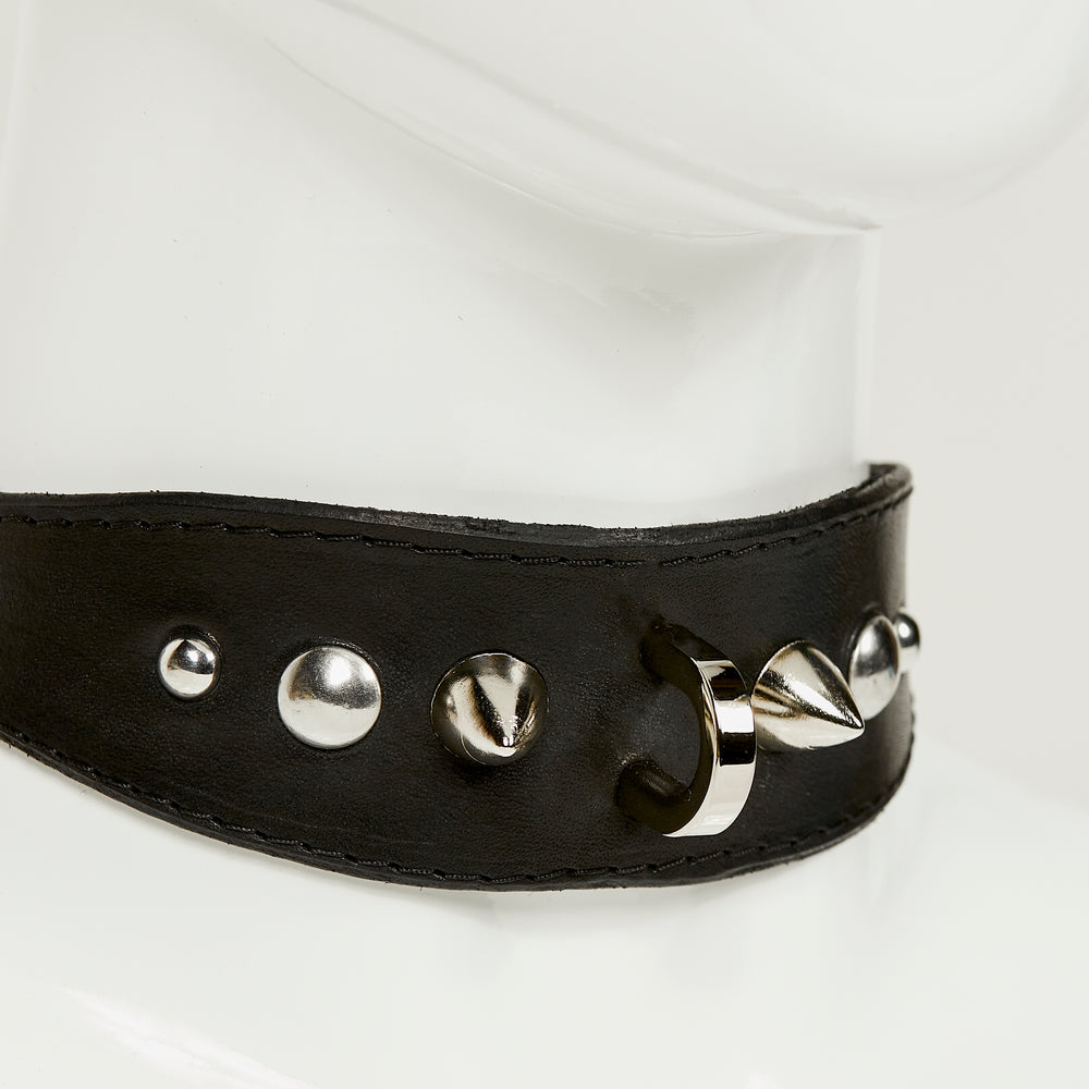 NIKKI COLLAR 3/4 close front view of medium width collar necklace in black leather with black stitched edges, accented with a gradation of silver rivets, spikes, and d-ring hardware