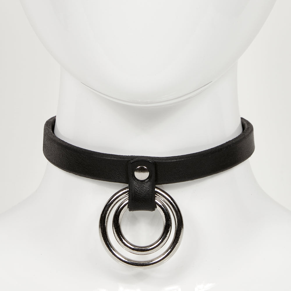 front view of slim leather choker on mannequin neck, with two concentric o-rings hanging from a strap rivited to main jewelry ERIN
