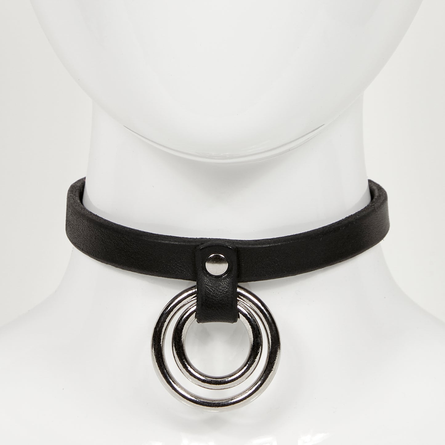 front view of slim leather choker on mannequin neck, with two concentric o-rings hanging from a strap rivited to main jewelry ERIN