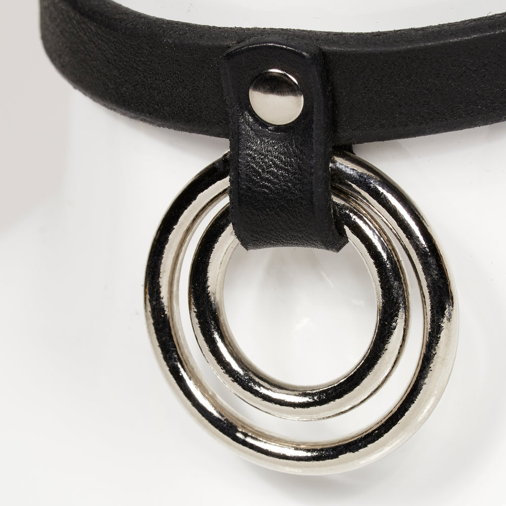 
                  
                    real close front view of two concentric o-rings hanging from a strap rivited to main leather jewelry ERIN
                  
                