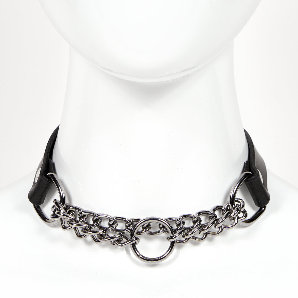 
                  
                    front fiew of medium width leather choker with silver chainlink suspended between two d-rings, silver style o-ring as centerpiece of chainlink MARTINGALE
                  
                