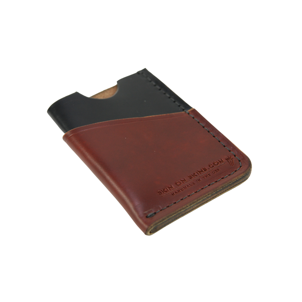 
                  
                    Front view of a rectangular wallet in a stylish, simple double-sleeve design, with debossed emblem, a black color base, and reddish brown tanned surface color
                  
                
